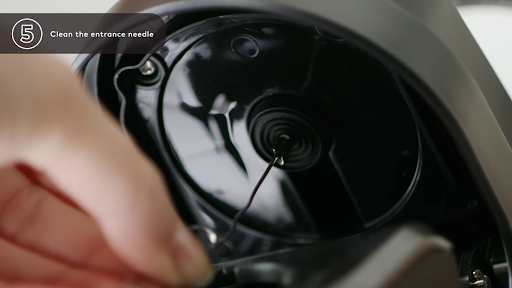 Remove the debris from inside the Keurig using the paperclip